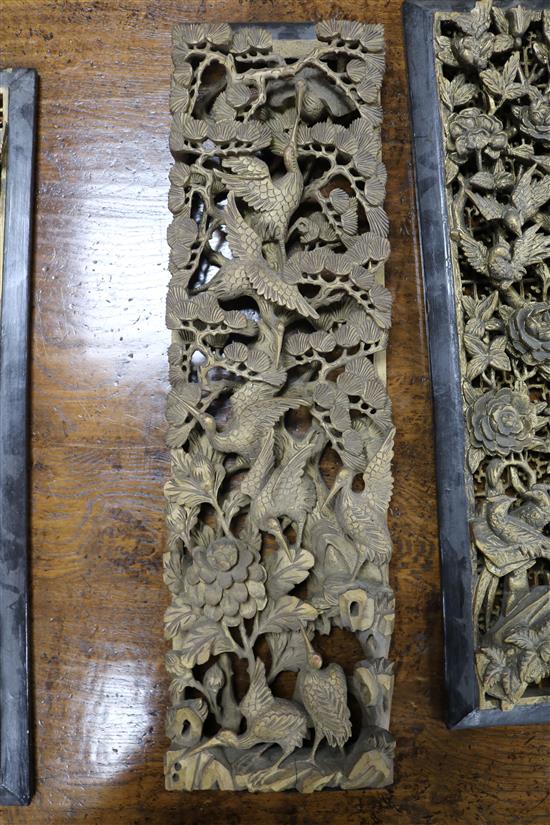Six Chinese carved giltwood upright panels, soldiers and birds amid foliage